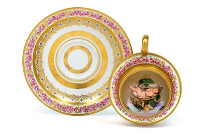 A teacup with small Bacchus and saucer, - Works of Art