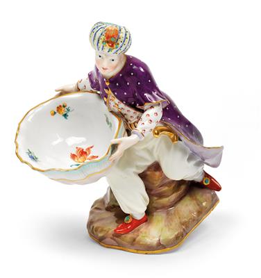 A seated Turkish man holding a shell bowl for spices, - Furniture and works of art