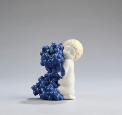 A seated child (putto) with grapes (autumn), probably Michael Powolny, model c. 1907/12, executed by Wiener Keramik, or Vereinigte Wiener und Gmundner Keramik or Gmundner Keramik - Jugendstil and 20th Century Arts and Crafts