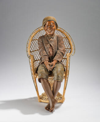 A large seated figurine: “Beim Photographen” (a seated boy with flat cap on a chair), model number 1226, designed in around 1897/98, executed by Friedrich Goldscheider, Vienna, by c. 1898 - Jugendstil and 20th Century Arts and Crafts