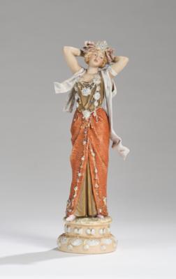 A female figure in a fancy dress with head jewel standing on a base with water lilies, model number 397, Royal Dux Porcelain Factory, c. 1910 - Secese a umění 20. století