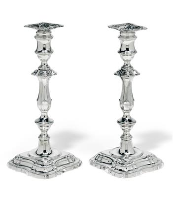 A pair of candleholders from London, - Silver and Russian Silver