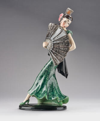 Stephan Dakon, a Spanish woman with a large fan striding, on an oval base, model number 7415, designed in around 1935-36, Wiener Manufaktur Friedrich Goldscheider, by c. 1941 - Jugendstil and 20th Century Arts and Crafts