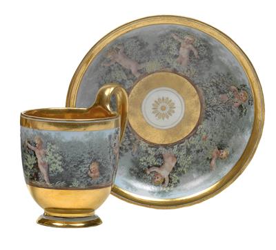 A cup and saucer decorated with cupids, - Glass and porcelain
