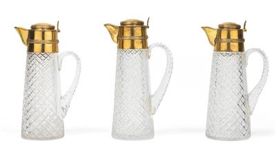 Three glass jugs with gilt silver lids, - Vetri e porcellane