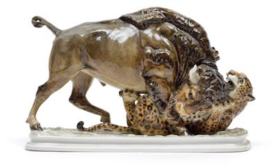 A figure of a bison fighting a leopard, - Glass and porcelain