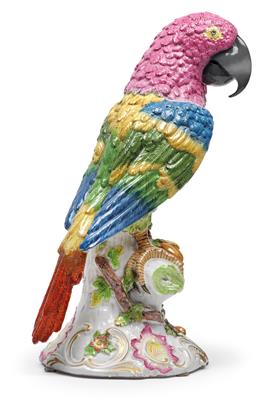 A figure of a parrot, perched on a tree trunk with leafy branches, - Vetri e porcellane