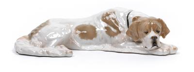 A figure of a sleeping dog, - Glass and porcelain