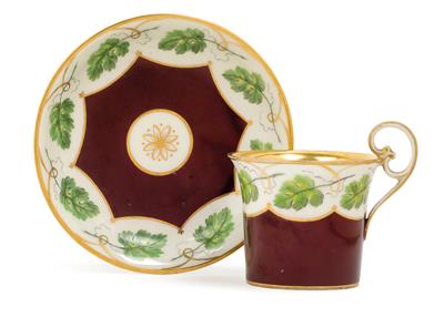 A cup and saucer with grape leaf décor, - Glass and porcelain