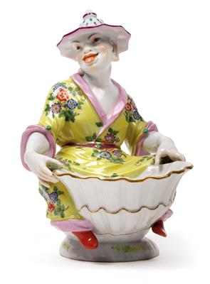 A seated Chinese figure holding a shell bowl, - Sklo a Porcelán