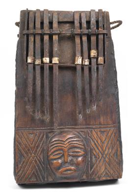 Mbunda, Zambia, Angola: A ‘sanza’ (thumb piano), with mask face in relief. - Tribal Art