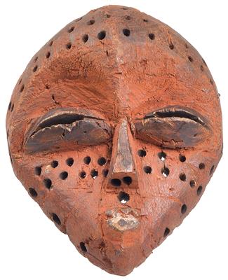 Eastern Pende, Democratic Republic of Congo: A small miniature mask, used as a protective amulet, and dyed red. - Arte Tribale