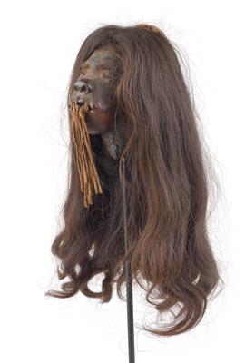 Shuar (or Jivaro), Equador: A ‘Tsantsa’ shrunken head, with long hair, tied up mouth, and carrying strap. 19th century. - Arte Tribale