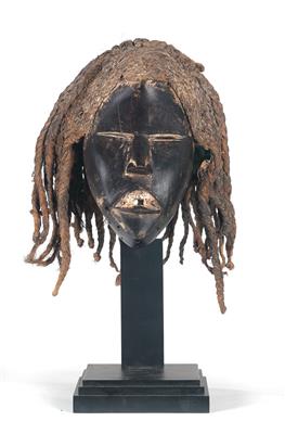 Dan, Ivory Coast, Liberia: A mask of the ‘Deangle’ type, with slit eyes and a coiffure of plant fibres. - Tribal Art