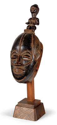 Bété, Ivory Coast: a mask, with a standing female figure on the top of the head. - Tribal Art