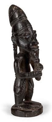 Yoruba, Nigeria: a figure of the god ‘Eshu’, blowing on a flute (or pipe). - Tribal Art