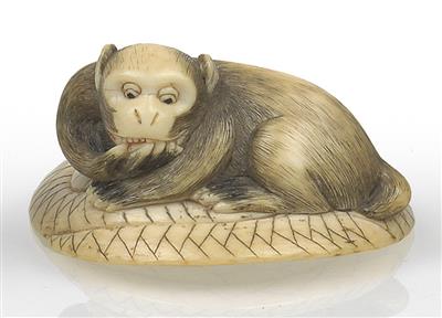 An ivory netsuke of a monkey on a straw matt - Asian art