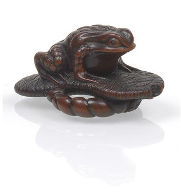 A wooden netsuke of a toad on a straw sandal - Asian art
