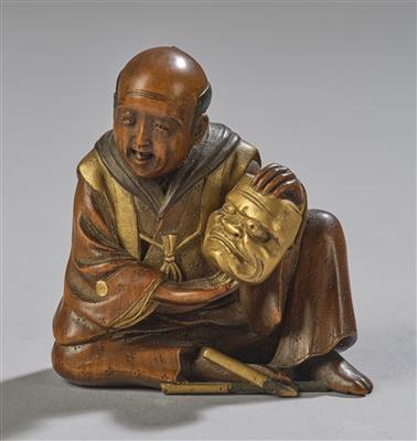 A Netsuke of a Seated Man with Mask, Japan, Meiji Period, 19th Century, Signed, - Asian Art